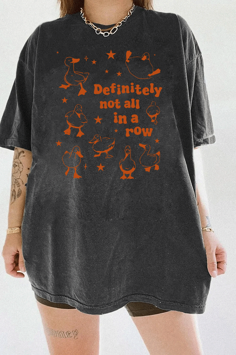 Dark gray T-shirt showcasing the 'Definitely Not All in a Row' graphic design, with a group of ducks in various poses and playful text, perfect for a fun and casual look.