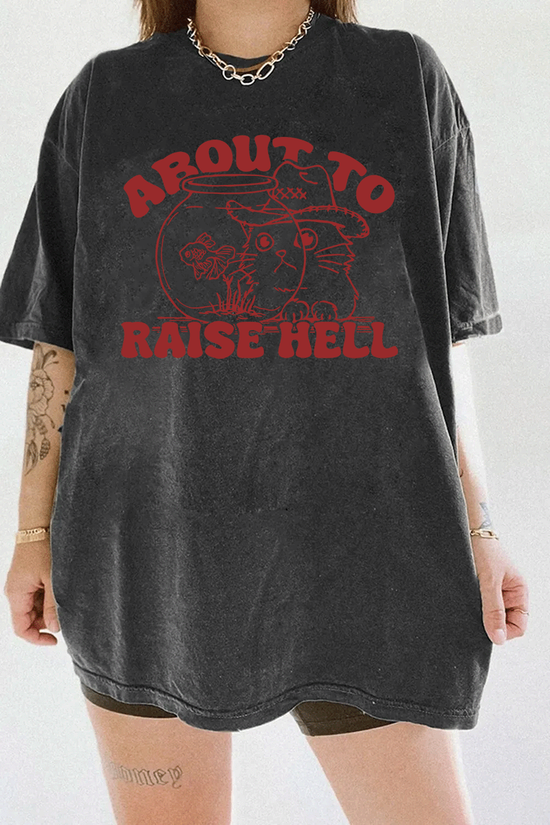 Ragglo dark gray women's t - shirt with 'About to Raise Hell' text and cat in cowboy hat graphic.