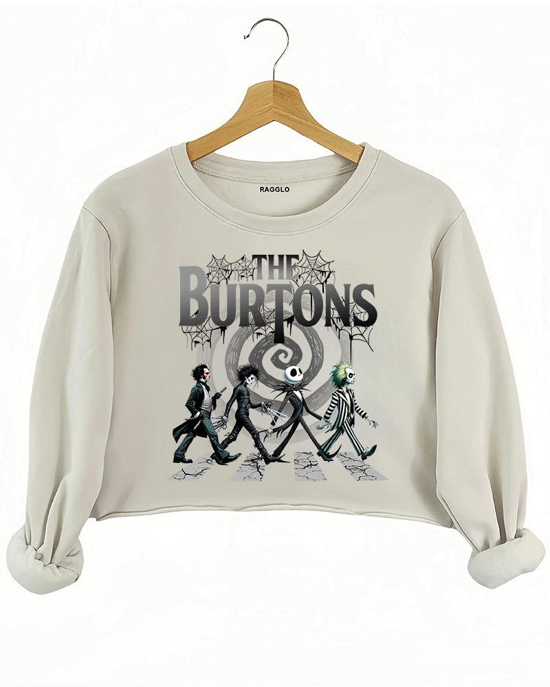 Ragglo beige cropped sweatshirt featuring The Burtons graphic, with beloved characters from Tim Burton's films walking across a cracked street in a stylized design.