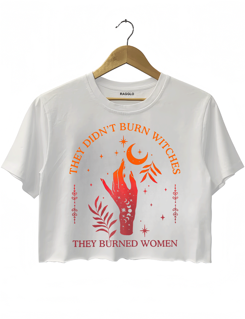 Ragglo white women's crop top with 'They Didn’t Burn Witches, They Burned Women' text and flaming hand with mystical symbols graphic.