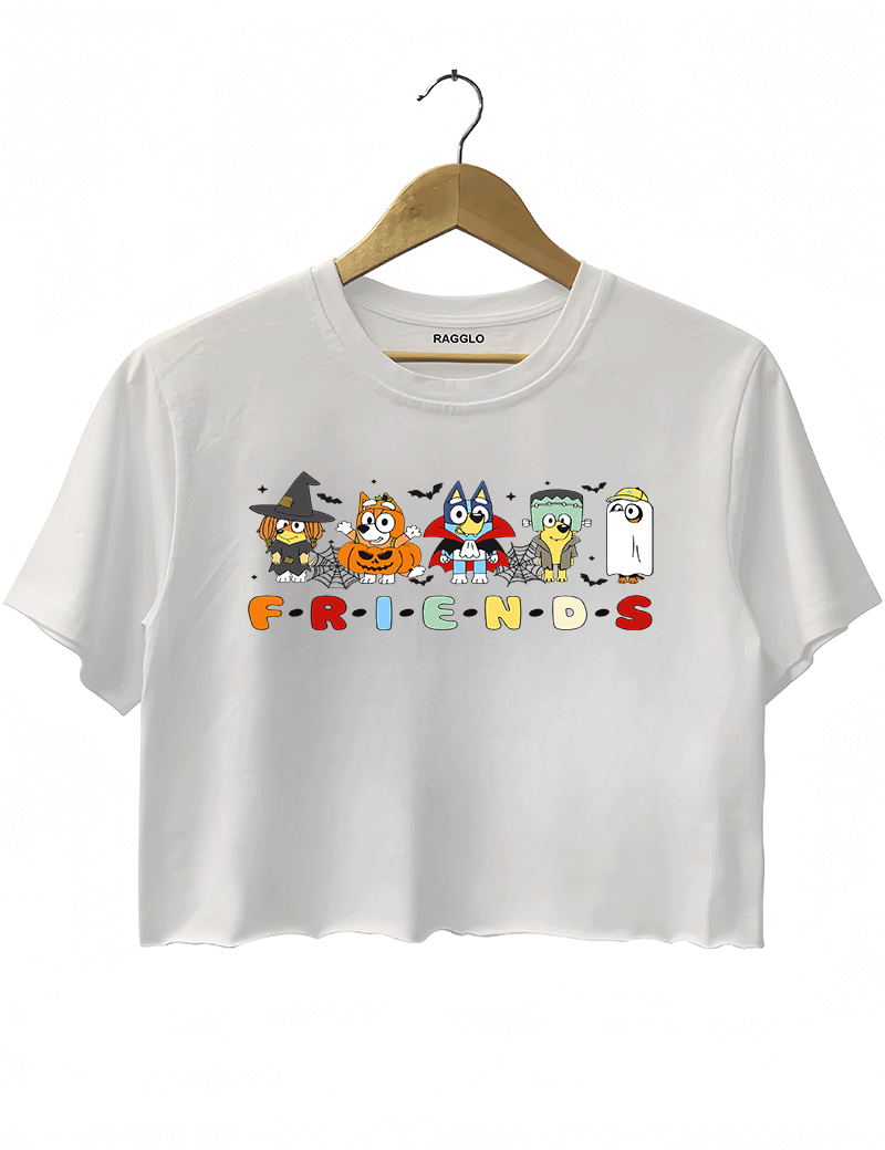 Ragglo white crop top featuring five Bluey characters in Halloween costumes as a witch, vampire, Frankenstein, construction worker, and ghost, with 'F·R·I·E·N·D·S' text in a Friends-inspired font, perfect for cute Halloween streetwear for animation fans.