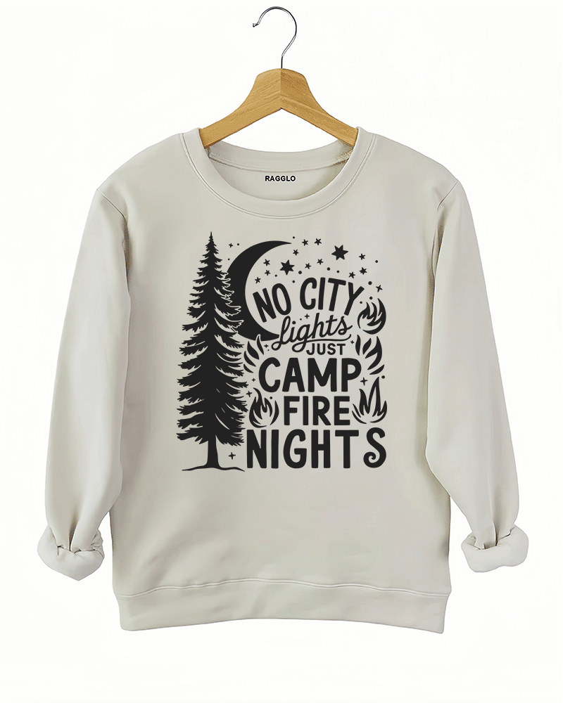 Ragglo beige sweatshirt featuring a pine tree, moon, stars, and campfire elements, with 'NO CITY LIGHTS JUST CAMP FIRE NIGHTS' text, perfect for outdoor camping streetwear for nature lovers.