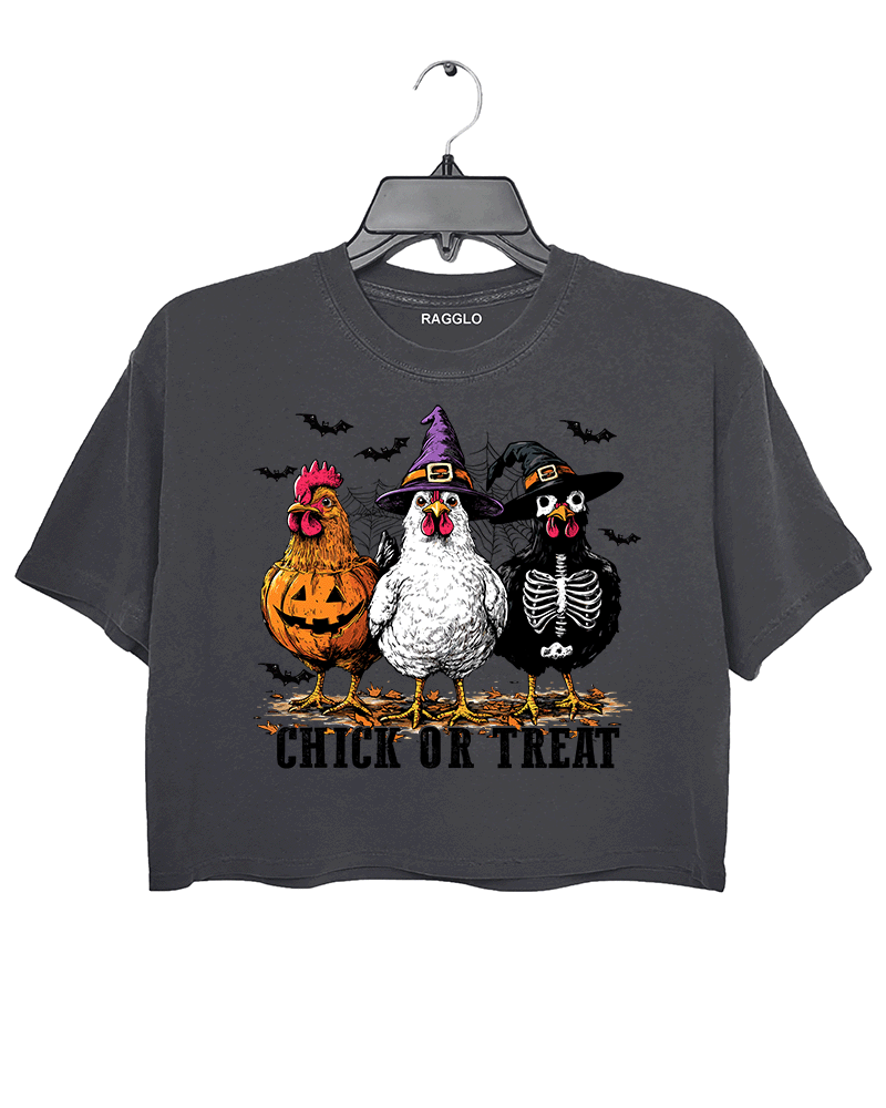 Ragglo dark gray crop top featuring three chickens in Halloween costumes with pumpkins, witch hats, and skeleton designs, accented by bats and spiderwebs, with 'CHICK OR TREAT' text, perfect for funny Halloween streetwear.