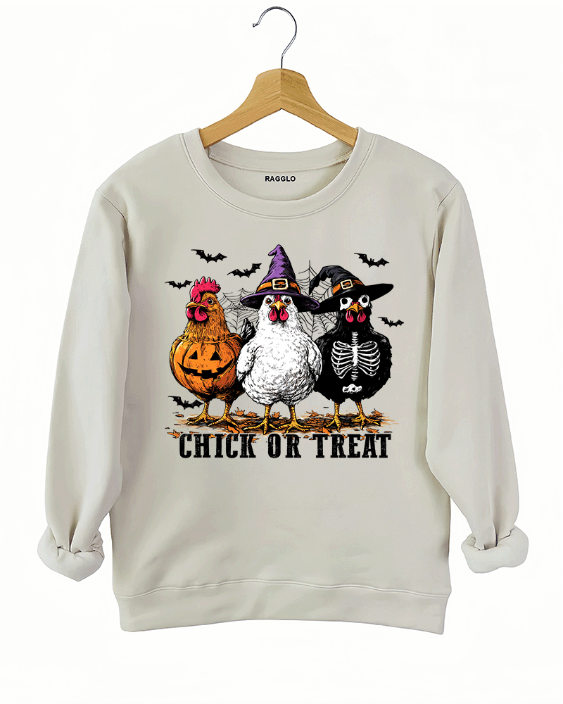 Ragglo beige sweatshirt featuring three chickens in Halloween costumes with pumpkins, witch hats, and skeleton designs, accented by bats and spiderwebs, with 'CHICK OR TREAT' text, perfect for funny Halloween streetwear.