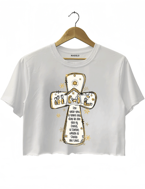Ragglo white crop top featuring a cross with a nativity scene, stars, and snowflakes, with 'Unto you is born this day in the city of David, a Savior which is Christ the Lord' text, perfect for religious Christmas streetwear.
