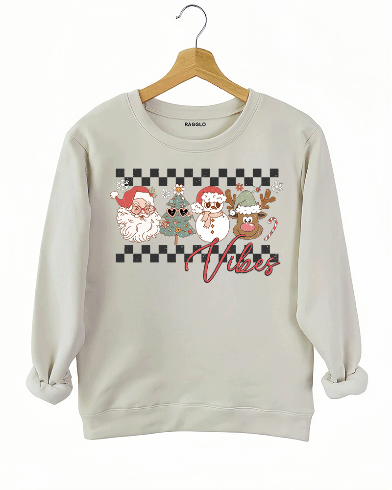 Ragglo beige sweatshirt with "Vibes" text and Christmas graphic featuring Santa, snowman, and reindeer, showcasing a festive holiday theme with a checkered background.