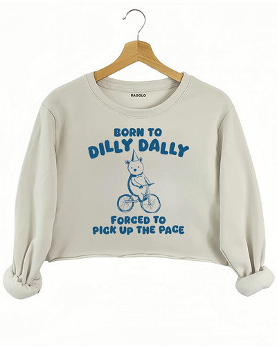 Ragglo beige crop sweatshirt featuring a bear in a party hat riding a bicycle with 'BORN TO DILLY DALLY FORCED TO PICK UP THE PACE' text, perfect for funny casual streetwear.