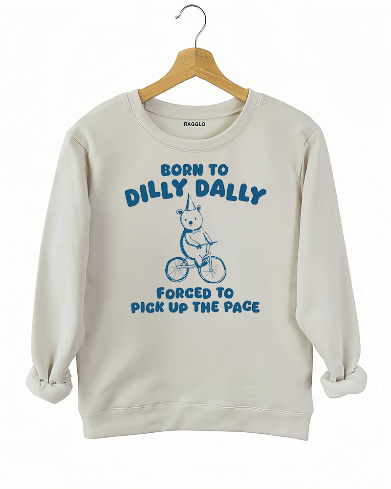 Ragglo beige sweatshirt featuring a bear in a party hat riding a bicycle with 'BORN TO DILLY DALLY FORCED TO PICK UP THE PACE' text, perfect for funny casual streetwear.