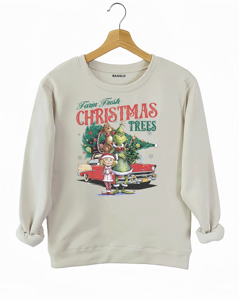 Ragglo beige sweatshirt featuring The Grinch, Cindy Lou Who, and Max with a decorated Christmas tree and vintage car, with 'FARM FRESH CHRISTMAS TREES' text, perfect for festive holiday streetwear.