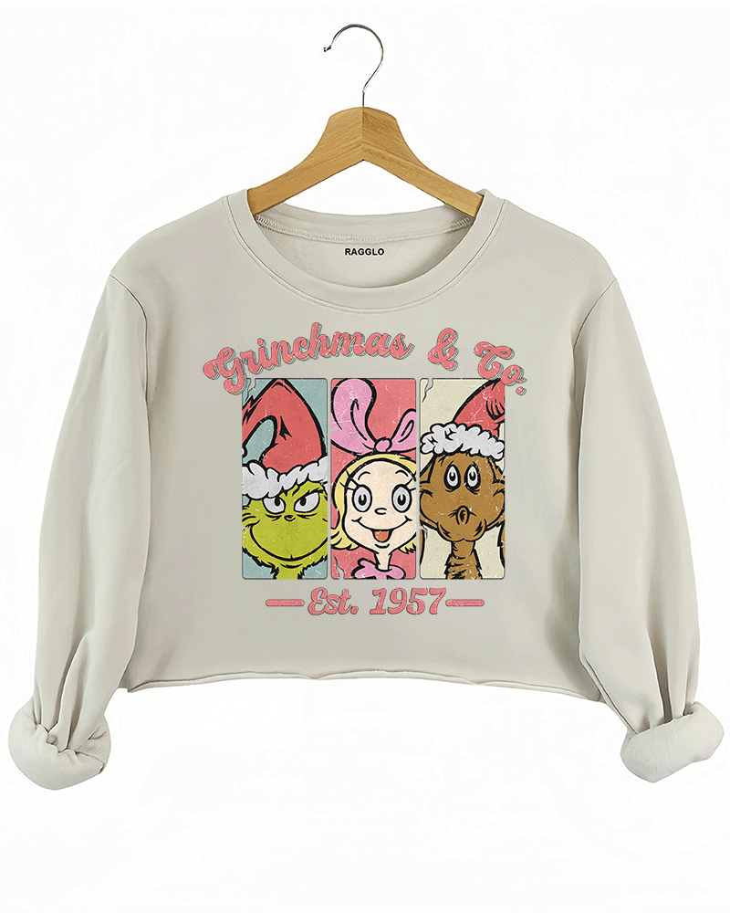 Ragglo beige crop sweatshirt featuring The Grinch, Cindy Lou Who, and Max in Santa hats with 'GRINCHMAS & GO' text and 'EST. 1957', perfect for festive holiday streetwear and Grinch fans.