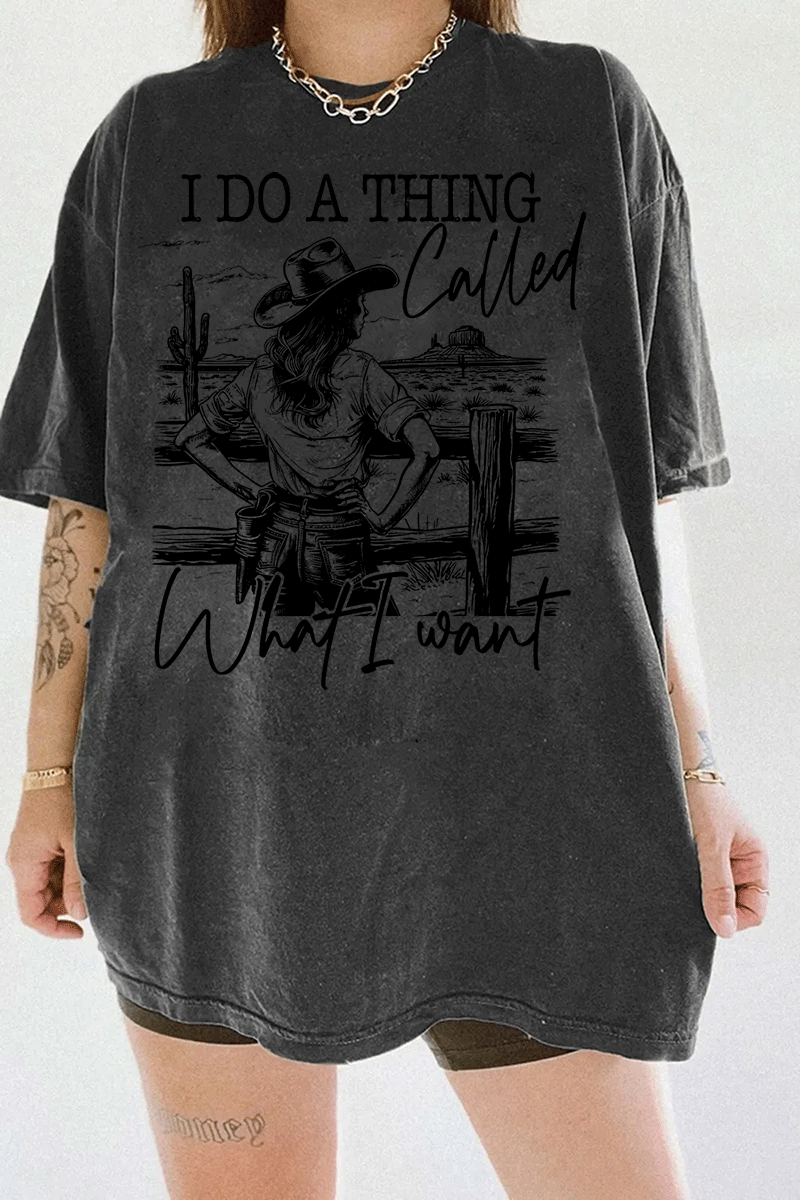 Ragglo dark gray T-shirt with "I Do A Thing Called What I Want" text and cowgirl graphic in a desert scene, featuring a bold western independence theme.