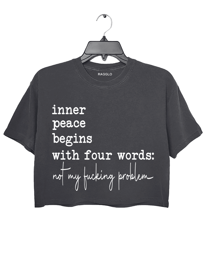 Ragglo dark gray crop top featuring 'inner peace begins with four words: not my f**king problem' text, perfect for sassy streetwear and carefree attitude enthusiasts.