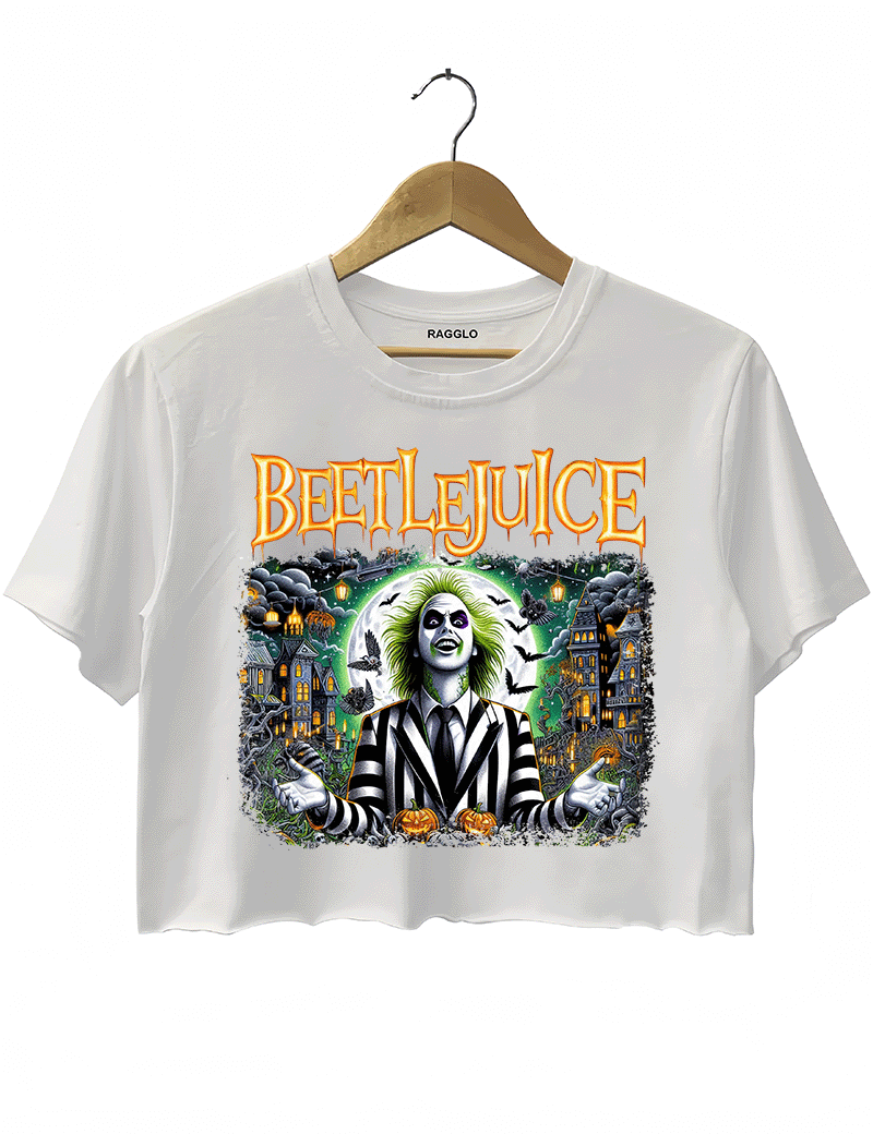 Ragglo white crop top featuring Beetlejuice in a black-and-white striped suit, with a haunted house, bats, and pumpkins in the background, with 'BEETLEJUICE' text, perfect for Halloween streetwear and movie fans.