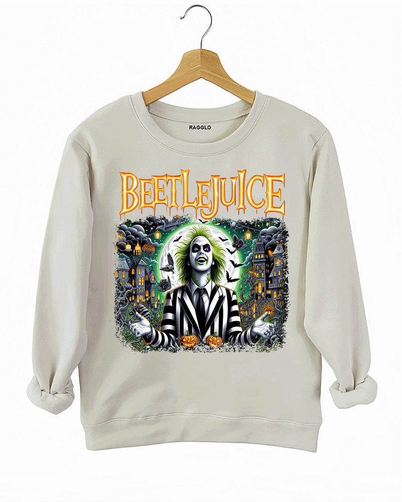 Ragglo beige sweatshirt featuring Beetlejuice in a black-and-white striped suit, with a haunted house, bats, and pumpkins in the background, with 'BEETLEJUICE' text, perfect for Halloween streetwear and movie fans.
