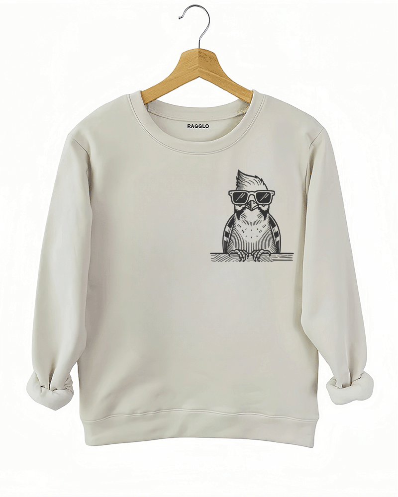 Ragglo beige sweatshirt front view showcasing a cool bird with sunglasses and a beard leaning on a ledge, perfect for humorous and trendy streetwear fashion.