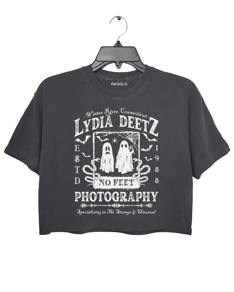 Ragglo dark gray crop top with "Lydia Deetz Photography No Feet" graphic featuring two ghosts, inspired by Beetlejuice with a gothic and supernatural theme.