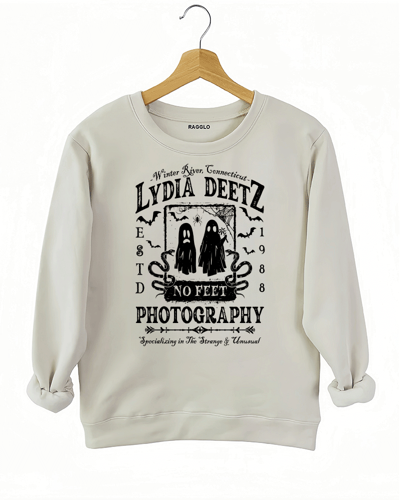 Ragglo beige sweatshirt with "Lydia Deetz Photography No Feet" graphic featuring two ghosts, inspired by Beetlejuice with a gothic and supernatural theme.