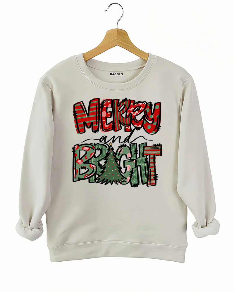 Ragglo beige sweatshirt featuring 'MERRY AND BRIGHT' text with red and green festive lettering and a Christmas tree design, perfect for holiday streetwear and festive celebrations.