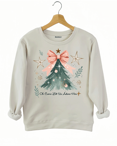 Ragglo beige sweatshirt featuring a Christmas tree with a pink bow, stars, snowflakes, and branches, with 'Oh Come Let Us Adore Him' text, perfect for religious Christmas streetwear.