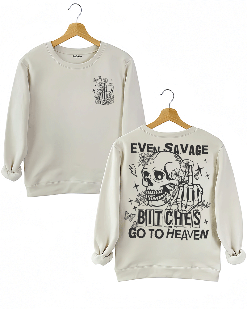 Ragglo beige sweatshirt featuring front and back views: the front shows a skeleton hand with a middle finger gesture surrounded by flowers, butterflies, and stars; the back displays a skull with a skeleton hand giving a middle finger, surrounded by flowers, butterflies, and stars, with 'EVEN SAVAGE BITCHES GO TO HEAVEN' text, perfect for bold and humorous streetwear.