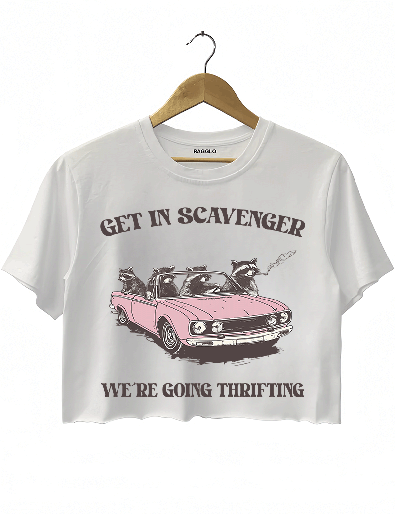 Ragglo white crop top featuring raccoons in a pink convertible car, with 'GET IN SCAVENGER WE’RE GOING THRIFTING' text, perfect for funny retro streetwear for thrifting enthusiasts.