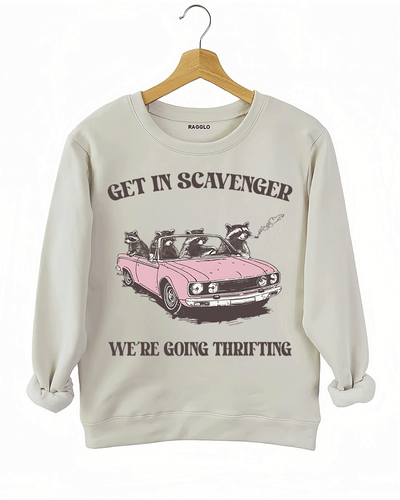 Ragglo beige sweatshirt featuring raccoons in a pink convertible car, with 'GET IN SCAVENGER WE’RE GOING THRIFTING' text, perfect for funny retro streetwear for thrifting enthusiasts.