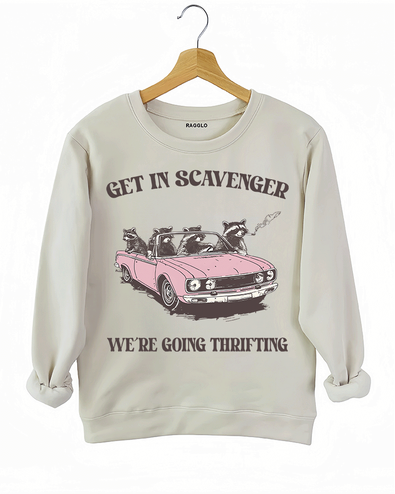 Ragglo beige sweatshirt featuring raccoons in a pink convertible car, with 'GET IN SCAVENGER WE’RE GOING THRIFTING' text, perfect for funny retro streetwear for thrifting enthusiasts.