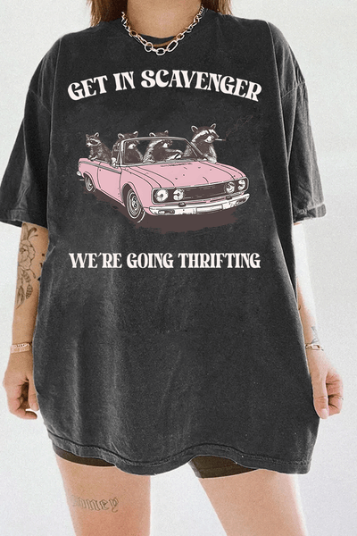 Ragglo dark gray tee featuring raccoons in a pink convertible car, with 'GET IN SCAVENGER WE’RE GOING THRIFTING' text, perfect for funny retro streetwear for thrifting enthusiasts.