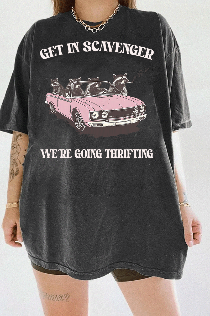 Ragglo dark gray tee featuring raccoons in a pink convertible car, with 'GET IN SCAVENGER WE’RE GOING THRIFTING' text, perfect for funny retro streetwear for thrifting enthusiasts.