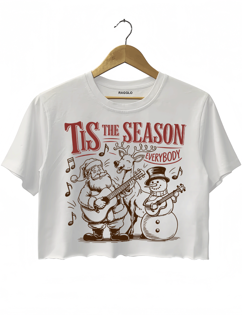 Ragglo white crop top featuring Santa, a reindeer, and a snowman playing guitars with musical notes and 'TIS THE SEASON EVERYBODY' text, perfect for festive Christmas streetwear with a musical vibe.