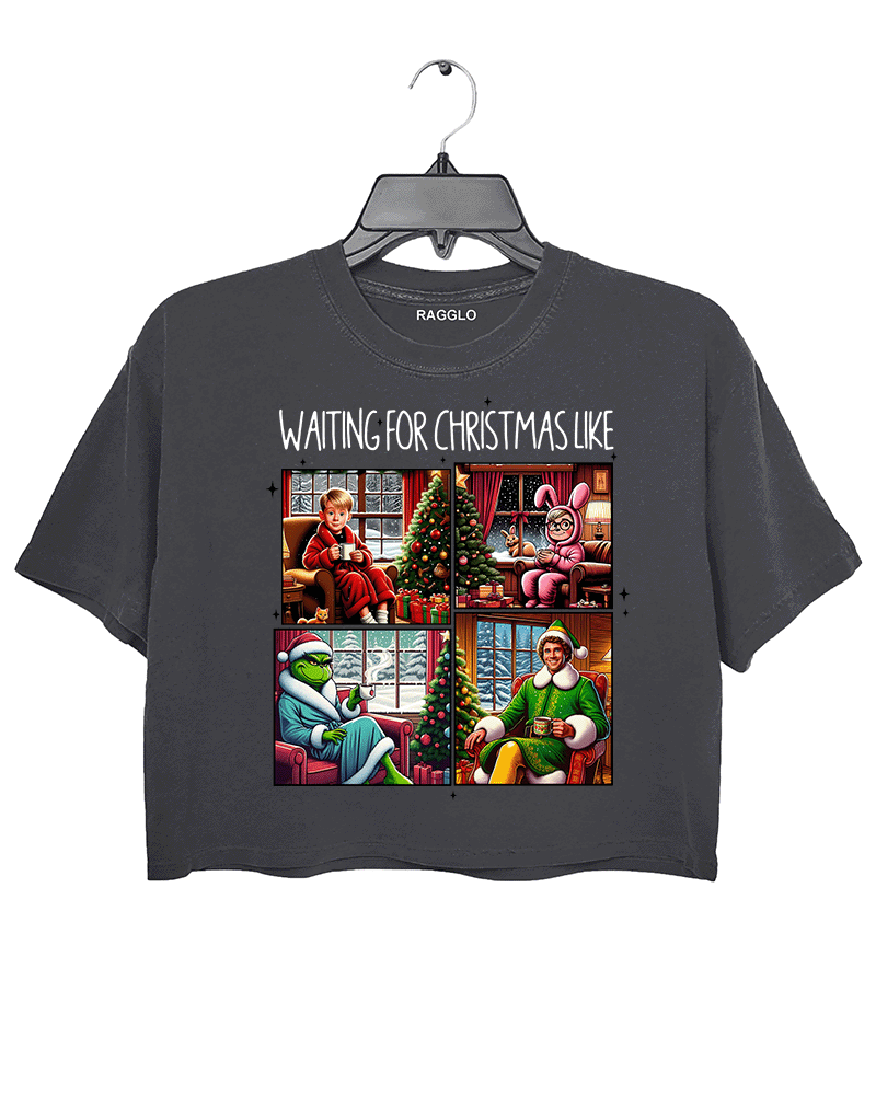 Ragglo dark gray crop top featuring four classic Christmas movie characters waiting by decorated trees with 'WAITING FOR CHRISTMAS LIKE' text, perfect for festive holiday streetwear and movie fans.