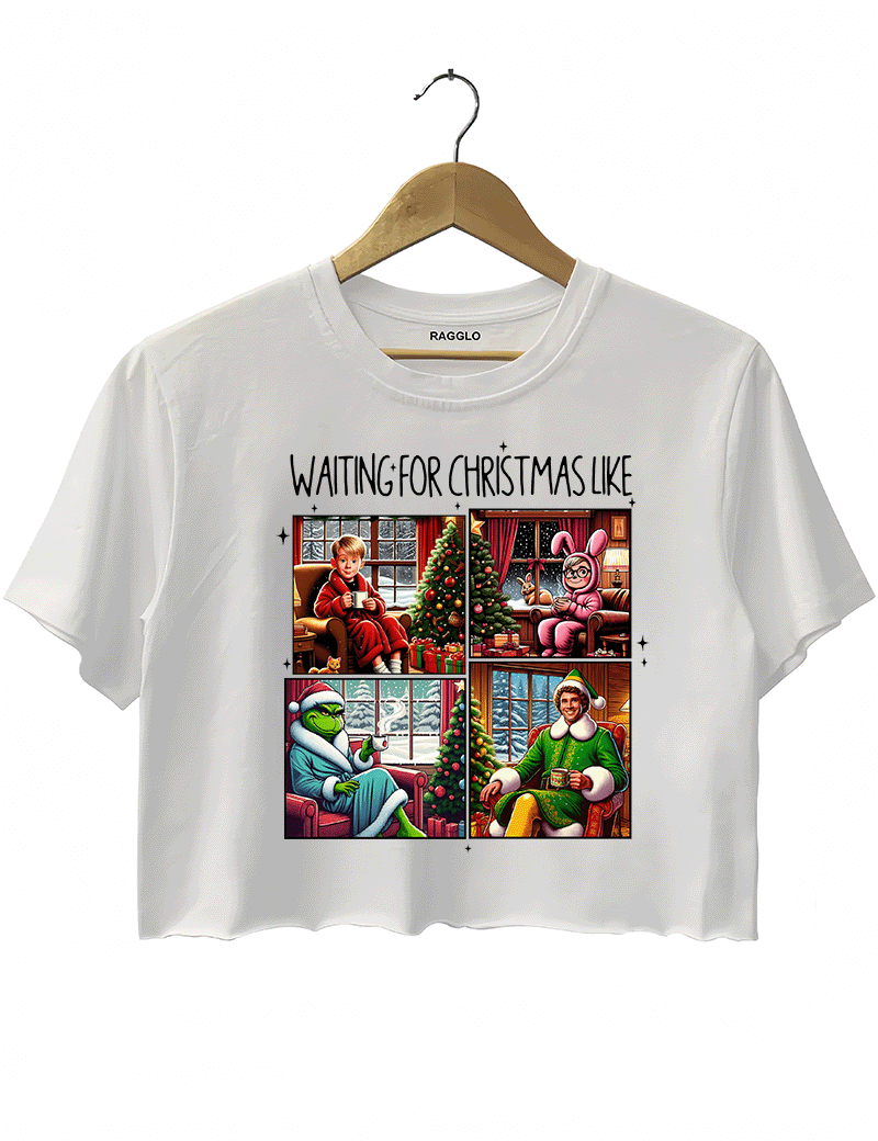 Ragglo white crop top featuring four classic Christmas movie characters waiting by decorated trees with 'WAITING FOR CHRISTMAS LIKE' text, perfect for festive holiday streetwear and movie fans.