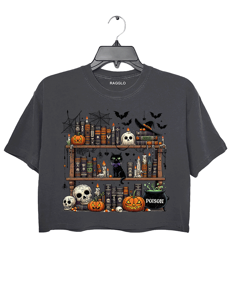 Ragglo dark gray crop top featuring a spooky bookshelf with magic books, pumpkins, skulls, a black cat, and a 'POISON' potion bottle, accented by bats and spiderwebs, perfect for Halloween streetwear and witchy vibes.