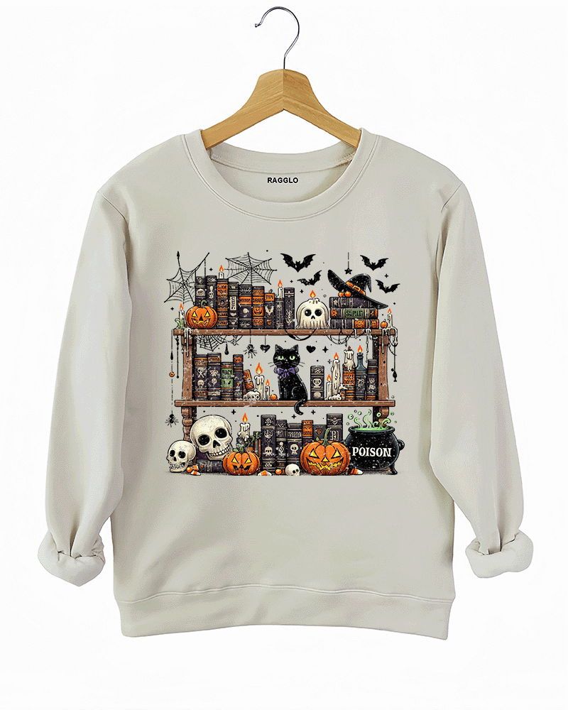 Ragglo beige sweatshirt featuring a spooky bookshelf with magic books, pumpkins, skulls, a black cat, and a 'POISON' potion bottle, accented by bats and spiderwebs, perfect for Halloween streetwear and witchy vibes.