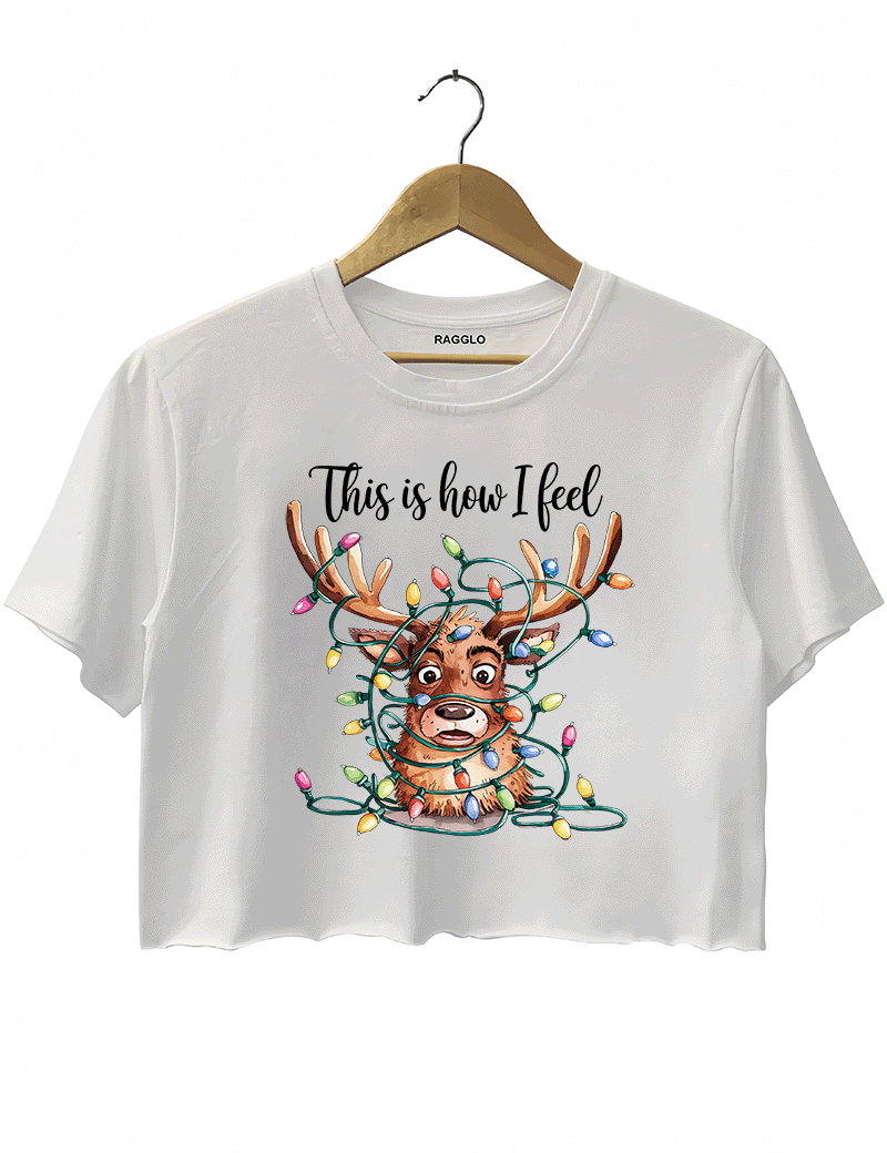 White crop top showcasing a confused reindeer wrapped in bright Christmas lights, with the fun phrase 'This is how I feel,' available on Ragglo.