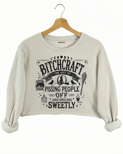 Beige crop sweatshirt with 'Bitch Craft' design available on Ragglo, combining comfort with a mystical, witchcraft-inspired style.