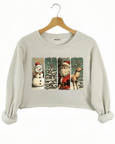 Retro Christmas graphic with a snowman, tree, Santa Claus, and reindeer on a beige crop sweatshirt, available on Ragglo.