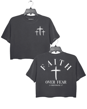 Dark gray Ragglo crop top with three small white cross designs on the front and "Faith Over Fear" with "2 Corinthians 5:7" text plus a prominent white cross design on the back.