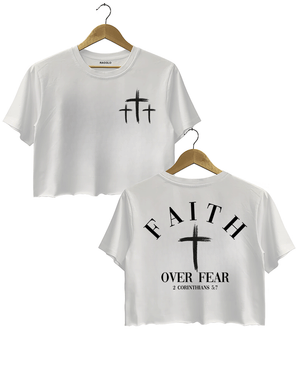White Ragglo crop top with three small white cross designs on the front and "Faith Over Fear" with "2 Corinthians 5:7" text plus a prominent white cross design on the back.