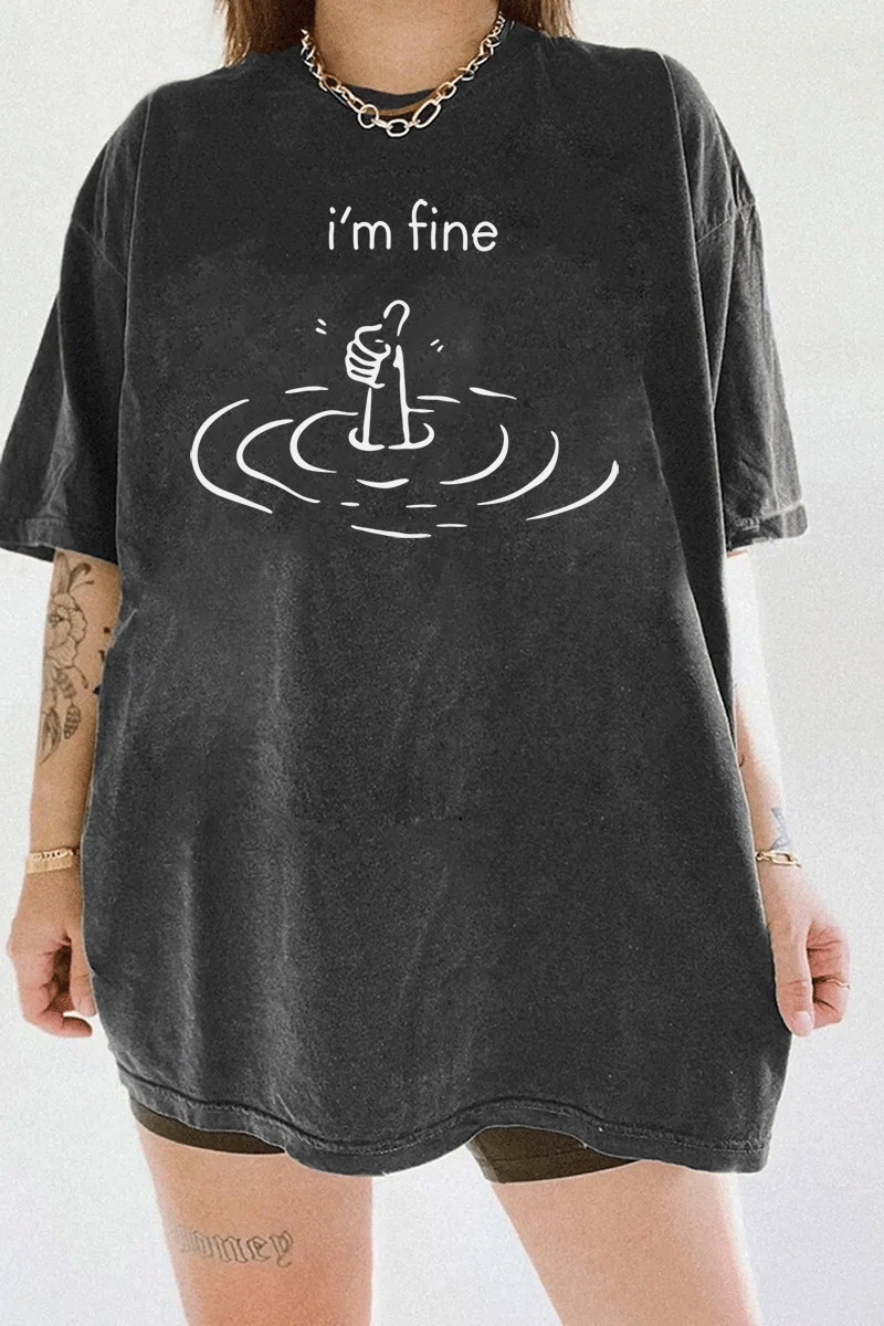 Dark gray T-shirt with a detailed graphic of a hand rising from water and giving a thumbs-up, expressing hidden struggles and outward positivity.