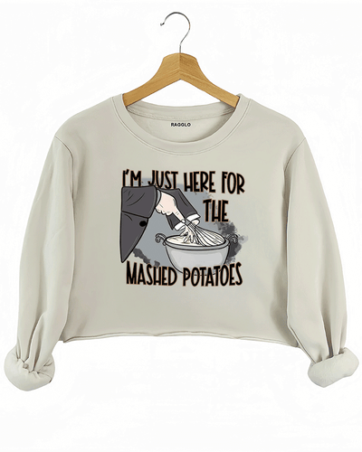 Funny beige crop sweatshirt with "I'm Just Here for the Mashed Potatoes" text and a hand mixing mashed potatoes graphic, perfect for Thanksgiving or food lovers.

