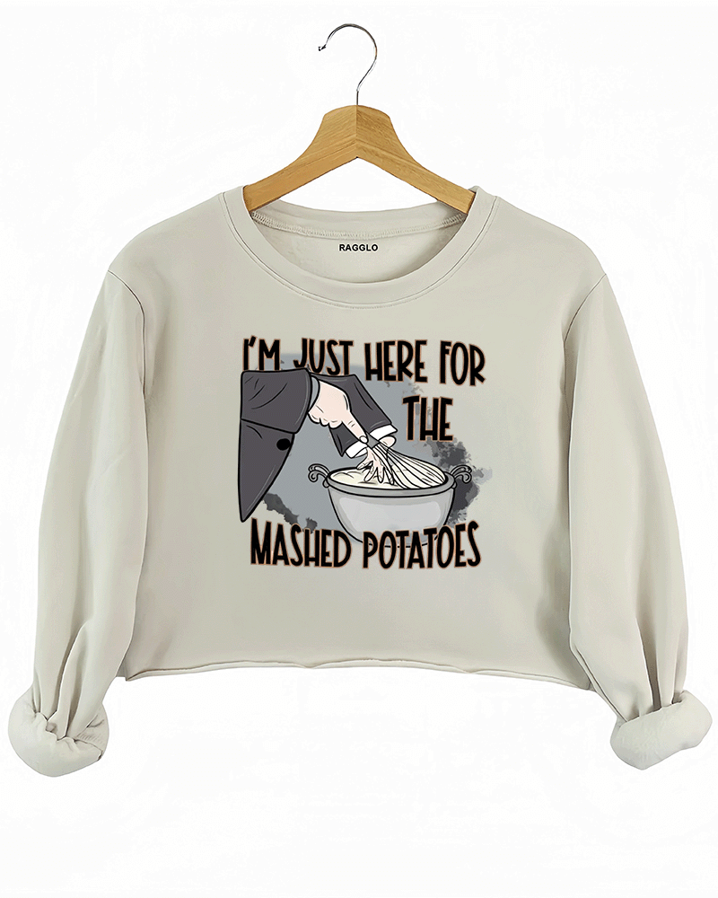 Funny beige crop sweatshirt with "I'm Just Here for the Mashed Potatoes" text and a hand mixing mashed potatoes graphic, perfect for Thanksgiving or food lovers.

