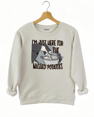 Funny beige sweatshirt with "I'm Just Here for the Mashed Potatoes" text and a hand mixing mashed potatoes graphic, perfect for Thanksgiving or food lovers.

