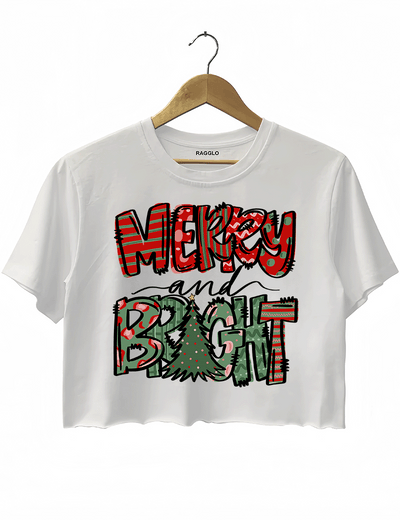 White crop top featuring the Merry & Bright Christmas graphic with colorful holiday patterns and a Christmas tree, available at Ragglo.