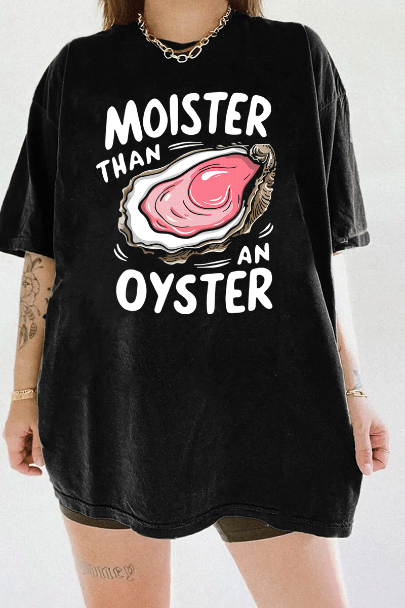 Black T-shirt with 'Moister than an Oyster' graphic design, featuring a juicy oyster illustration and playful bold text, creating a cheeky, humorous vibe.