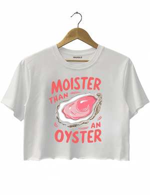 White crop top featuring the 'Moister than an Oyster' graphic, showcasing a plump pink oyster with large playful text, adding a touch of humor and fun.