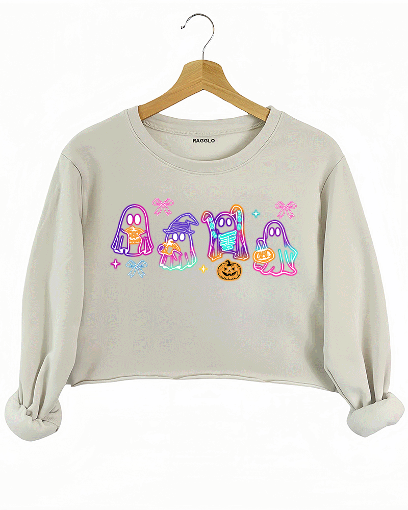 Ragglo beige cropped sweatshirt featuring five neon-style cartoon ghosts in Halloween costumes with bows and pumpkins, perfect for festive fashion and casual wear.