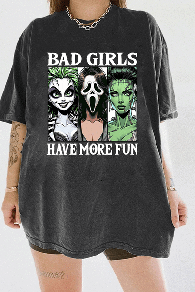 Ragglo dark gray horror-themed t-shirt with "Bad Girls Have More Fun" text and illustrations of three iconic horror characters, ideal for Halloween and horror movie fans.

