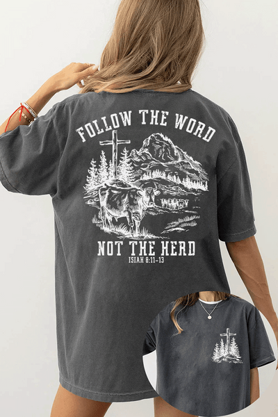 Ragglo dark gray women's T-Shirt featuring a minimalist cross and trees design on the front, and a mountain landscape with cattle, a cross, and trees on the back with the text 'Follow The Word Not The Herd' and 'Isaiah 8:11-13' in a faith-inspired graphic design.
