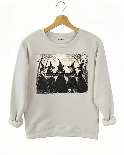 Ragglo beige women's sweatshirt featuring five witches in black hats holding a sign with the text 'Girls Will Be Girls' in a spooky forest background.